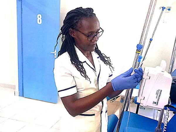 Trained Nurse Theresia Mukethe performs clinical duties at a health facility in Kenya