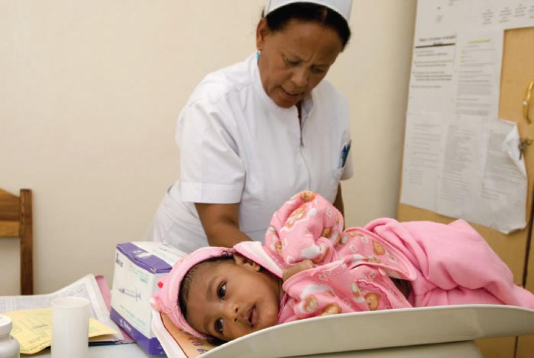 At a baby clinic in Ethiopia, 3-month old Hailu is weighed, vaccinated and given vitamin A by a frontline health worker. Photo by Jenny Matthews for Save the Children.