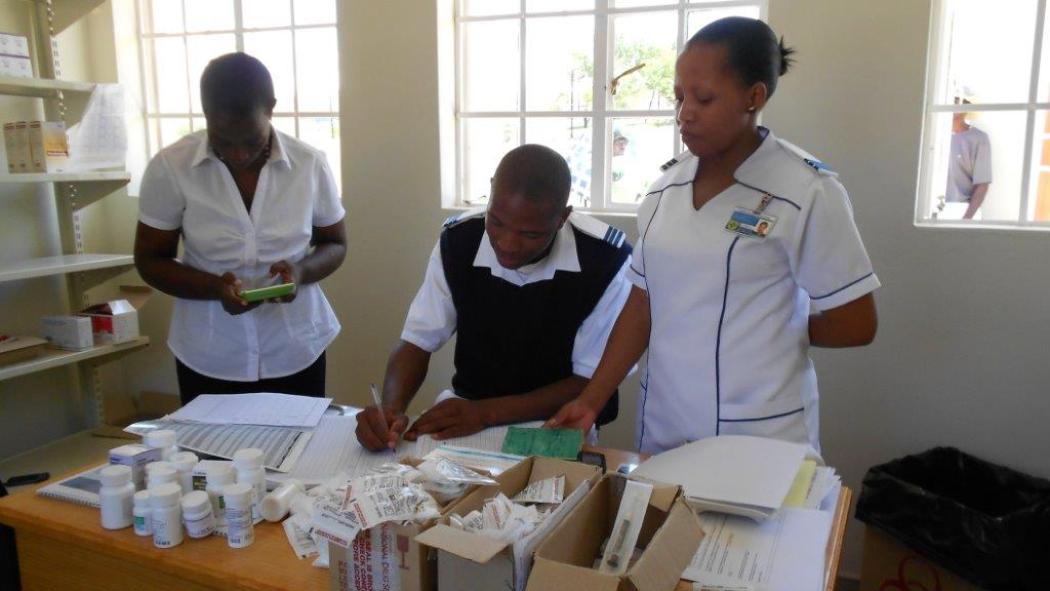 A preceptor teaches nursing students how to calculate ART adherence. Courtesy Semakaleng Phafoli / Jhpiego.