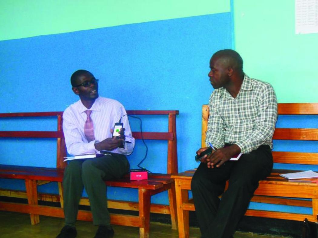 Dr. Rabson Kachala, Deputy Director of Sector Wide Approach, explaining supportive supervision results to Dr. Owen Chikhwaza of the Balaka District Health Office. Photo courtesy of Abt Associates.