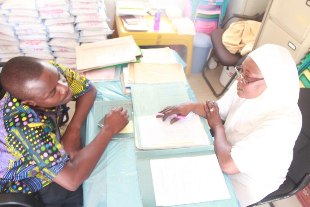 Thanks to Tanzania’s new task sharing policy, enrolled nurses such as Mwanamshamu Jangama (right) and other community- or district-level health or social service personnel have been empowered to provide critical treatment and care to patients with HIV and other conditions in rural, underserved areas throughout the country. Photo Courtesy of American International Health Alliance.