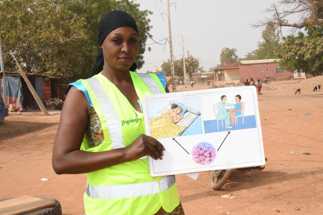 Belguissa Ouédraogo, a community health worker in Burkina Faso, visits women in her community to share critical health information. Photo courtesy of Jhpiego