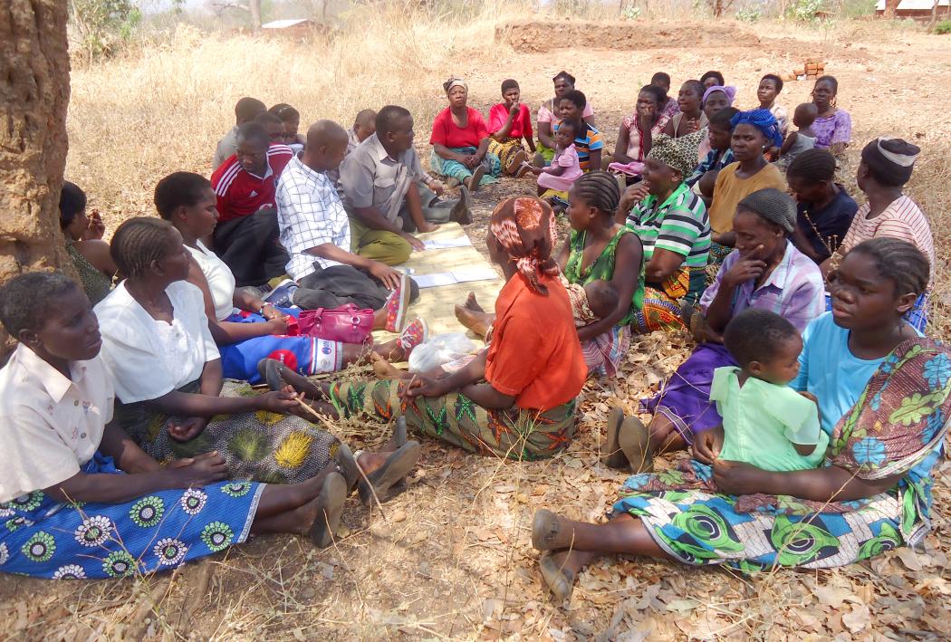A group of people in Malawi meet to discuss the state of health services in their community, using CARE’s Community Score Card© approach. © 2015 CARE