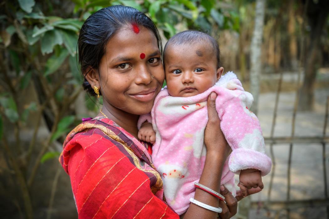 A happy mother with her healthy child, thanks to World Vision nutrition classes in southwest Bangladesh, where nutrition facilitators run courtyard feeding sessions for local moms and babies. World Vision is a member of the Frontline Health Workers Coalition. © 2019 World Vision, Jon Warren