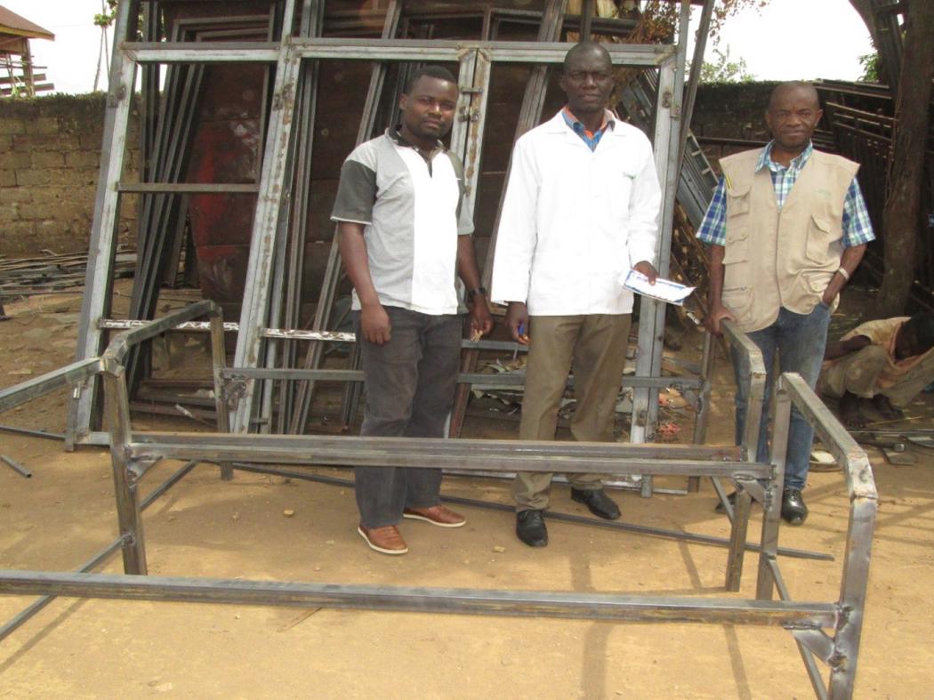 Elie (right), head nurse at a health facility in the north Kivu region of the Democratic Republic of Congo, helps repair a hospital bed. 