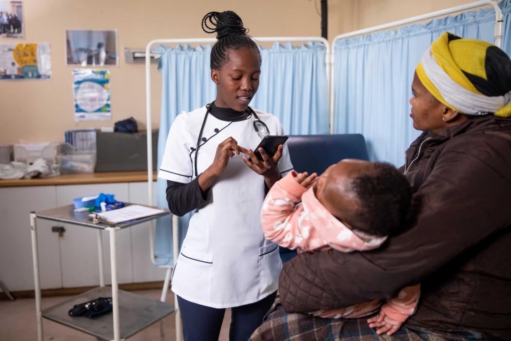 A frontline health worker uses THINKMD's clinical risk assessment tool to help a mother determine if her baby is sick and what best next steps to take. Photo courtesy THINKMD. 