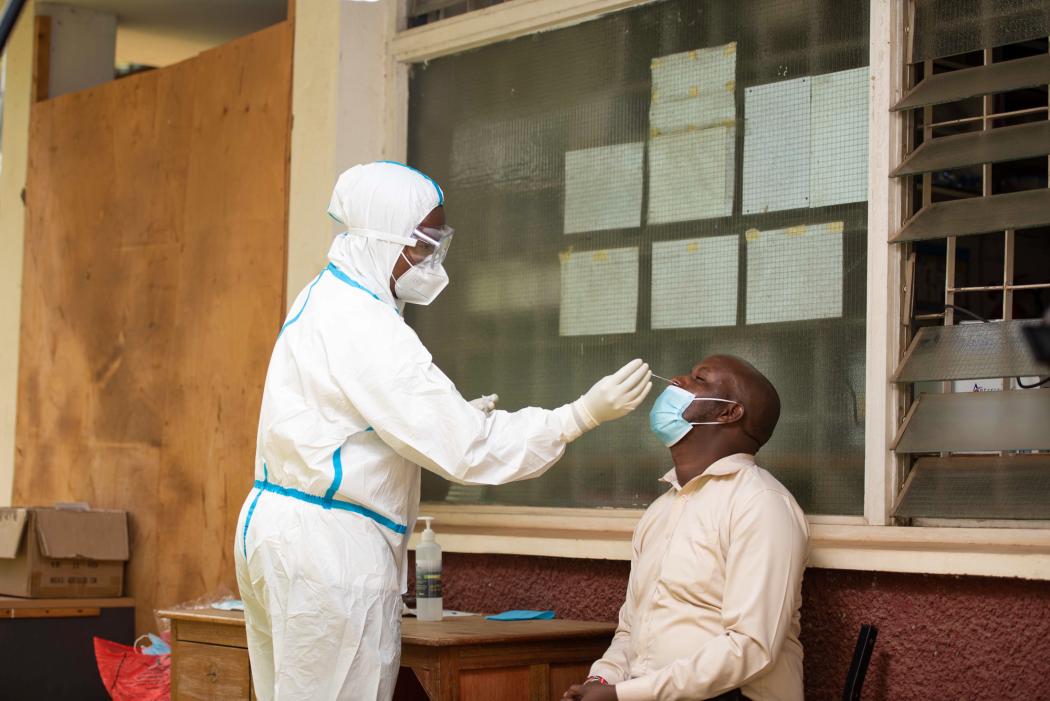 Babito, a medical lab technologist at Westlands Medical Center in Kenya, takes COVID-19 patient samples and stores them before they are taken to the lab for testing. Phot by Edwin Joe for IntraHealth International.