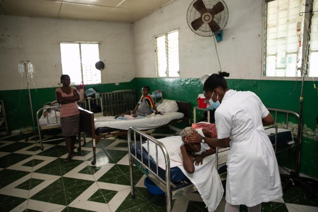 A health worker caring for patients at Immaculate Conception Hospital in Les Cayes, Haiti, where Project HOPE has provided medical staff, medicine, health infrastructure support, and hygiene supplies to improve the community's access to cholera treatment and primary health services. Photo by Nadia Todres for Project HOPE, 2023.