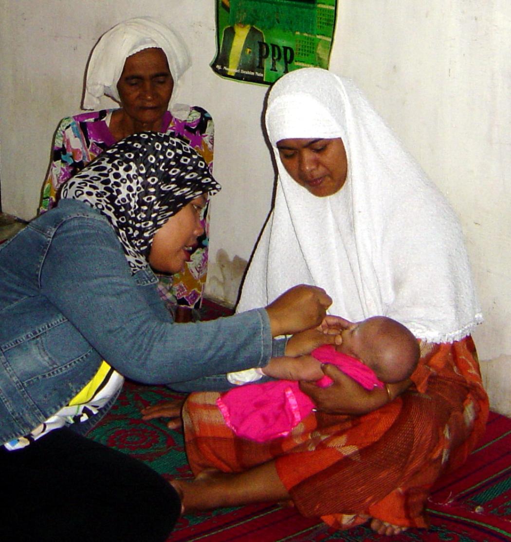 In Indonesia, an International Medical Corps health worker vaccinates a 20-day-old baby. Photo courtesy International Medical Corps.