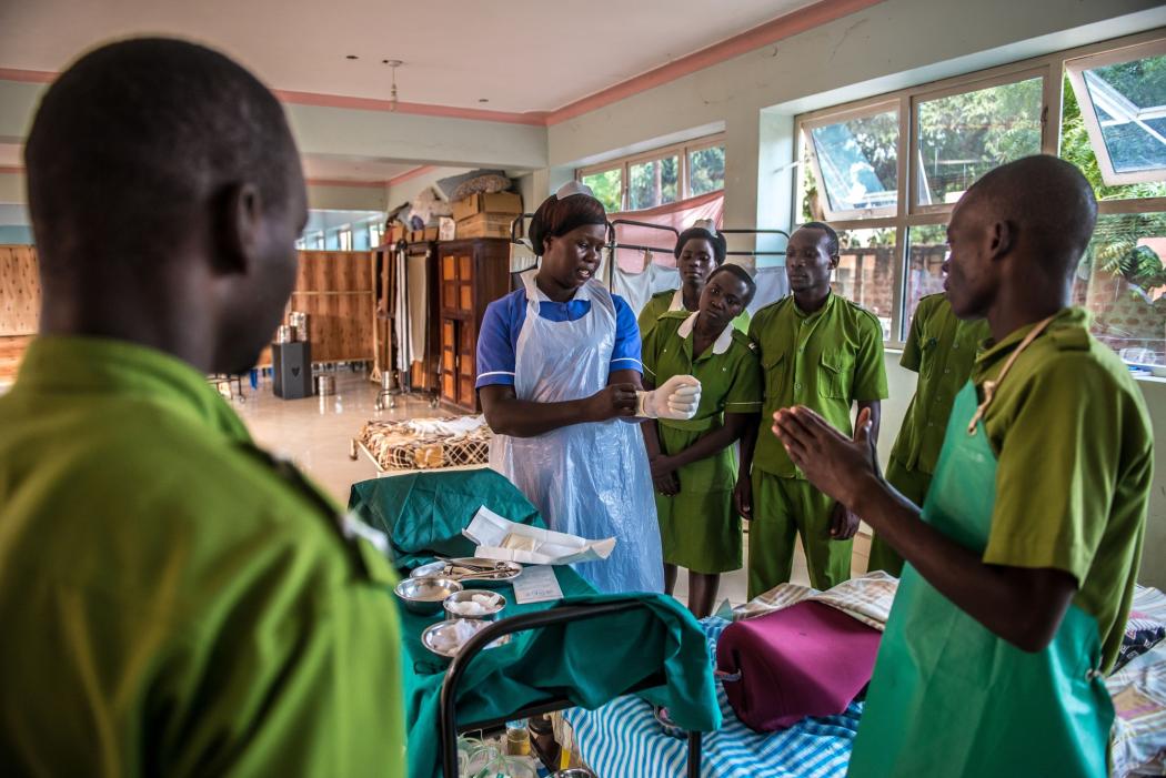 Beatrice Aciro, midwife and graduate of Good Samaritan School of Nursing &amp; Midwifery, conducts a practical exercise with students. Photo by Tommy Trenchard for IntraHealth International