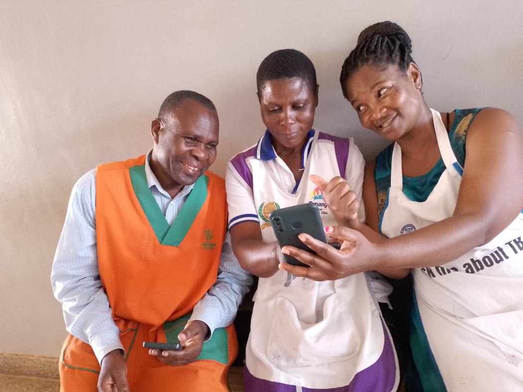 Village health team workers in Wakiso, Uganda receive their stipends via E-Cash. The improved efficiency of payments through E-Cash has boosted health worker morale. Photo by Benon Tumwine, UHSS Project.