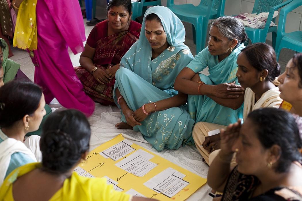 At a monthly Accredited Social Health Activist (ASHA) meeting at Sunhati Khadkhadi community health center, ASHAs conduct a group exercise and present their findings about handling newborn babies. ASHAs are effective at communicating and changing behaviors at the community level because they are from communities they serve. Photo by Trevor Snapp, IntraHealth International