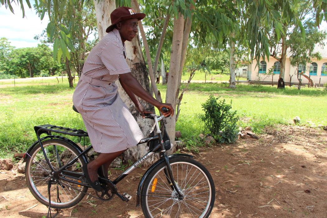 Regina, a community health worker in Zimbabwe, rides her bicycle to visit a household in her rural community. Photo courtesy of World Bicycle Relief.