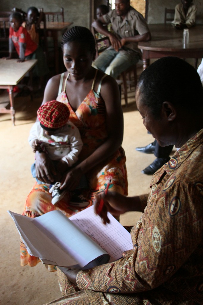 Community health worker Atangana Manga of PSI's local Cameroonian affiliate ACMS, discusses her son's health with a mother in his community. Courtesy PSI.