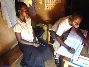 VHT member Togonzangane Steven  registering a client in a household. Courtesy Accordia Global Health Foundation.
