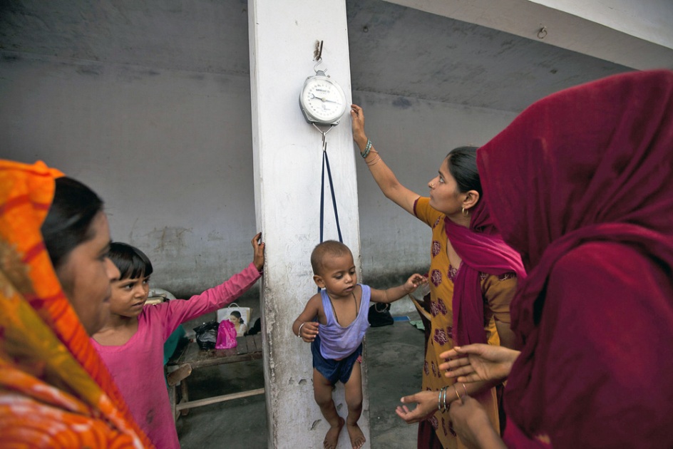Photo of a child being weighed during a Village Health and Nutrition Day at Chakvali Subcenter by Trevor Snapp, courtesy of IntraHealth International.